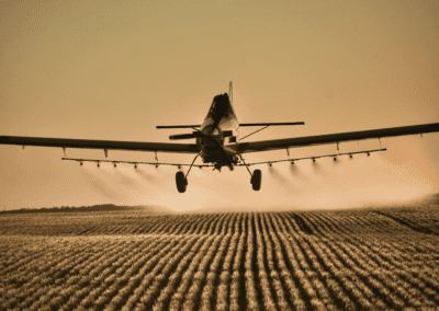 Tarrickfic Aerial plane spraying a field at dusk